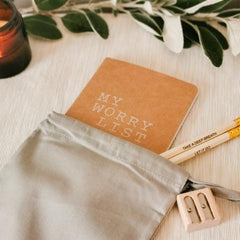Brown notebook with 'my worry list' in white text