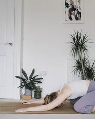Female in yoga pose child's pose