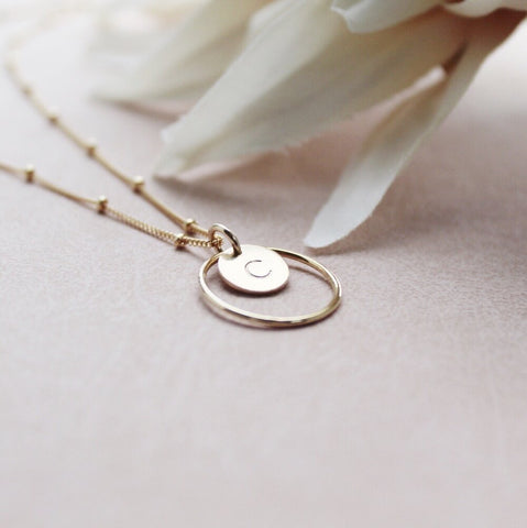 Gold necklace with personalised initial surrounded by gold circle