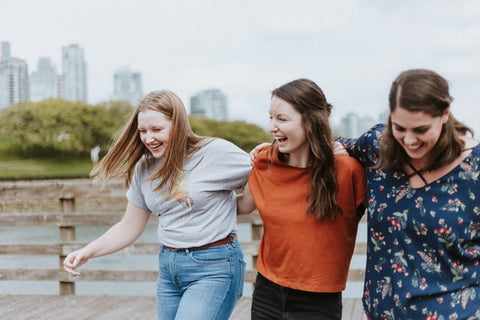 three friends with arms round eachother
